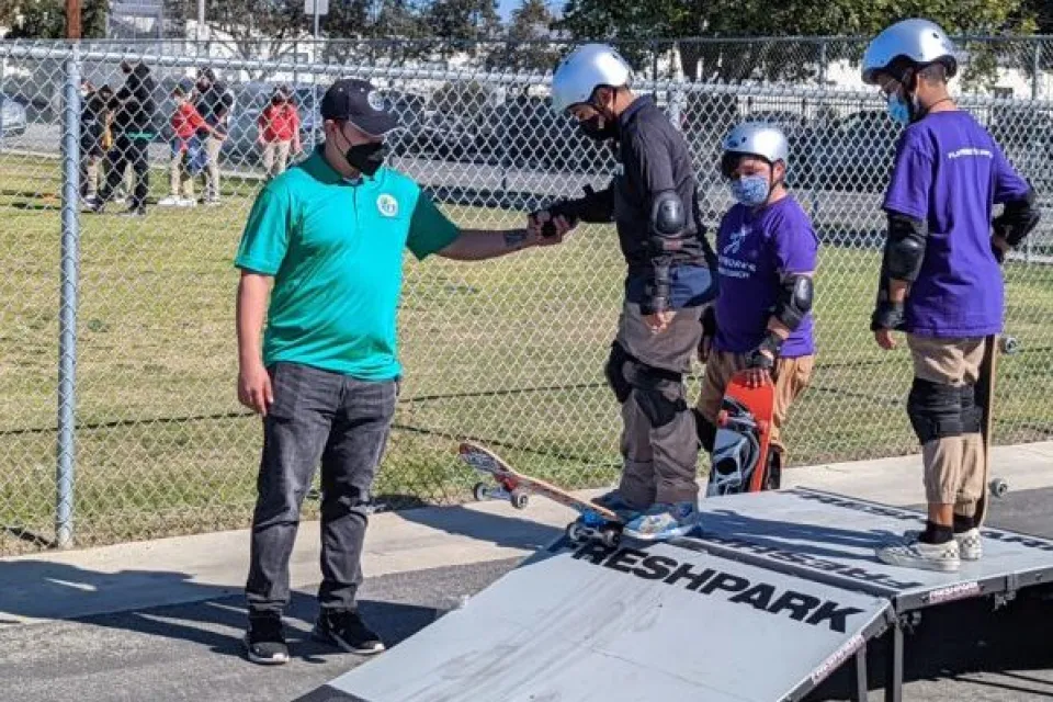 Children learning to skateboard